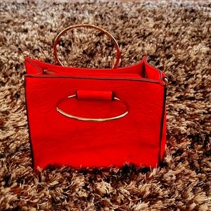 Red w gold handle and gold feet on the bottom